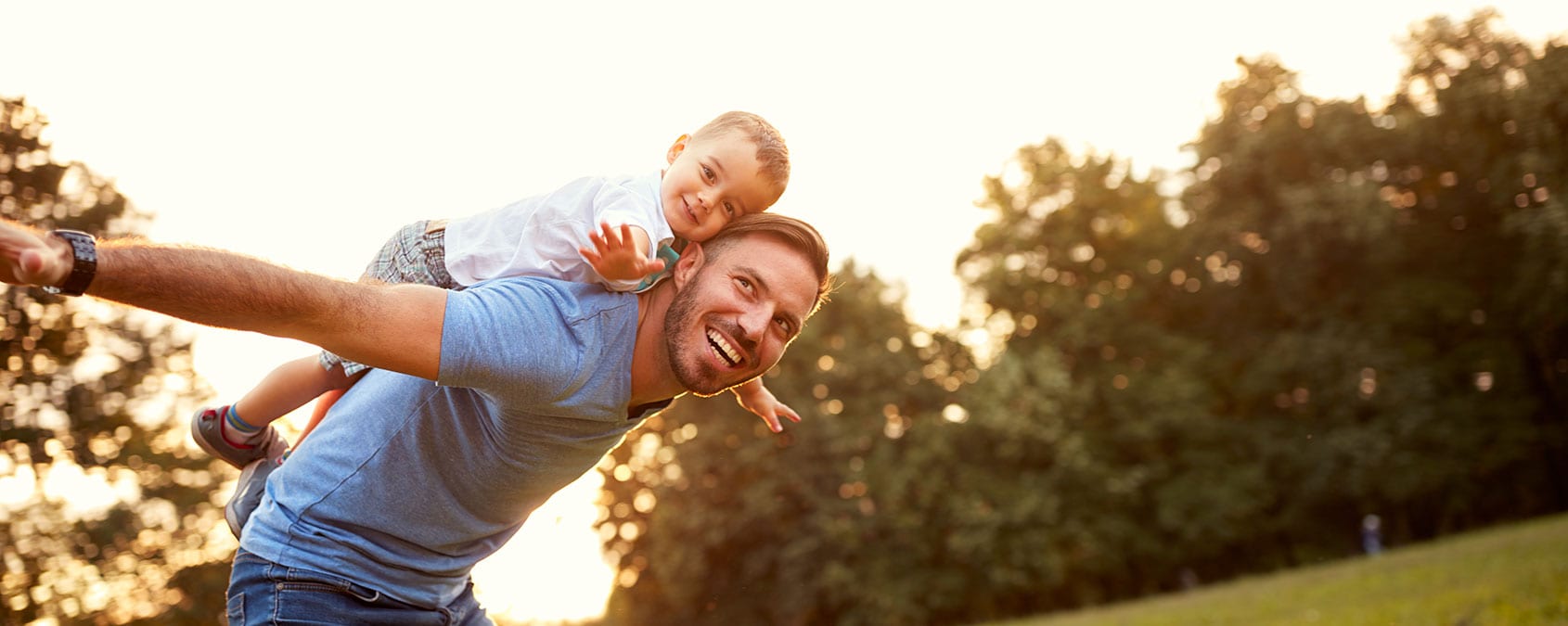 Father piggyback his little son outside